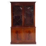 An early 19th century mahogany, walnut crossbanded and ebony strung bookcase cabinet,