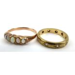 A yellow metal ring set five graduated opals and a 9ct yellow gold ring eternity ring set paste,