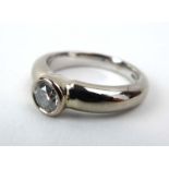 An 18ct white gold ring set brilliant cut diamond in a rubover setting, stone approximately 0.