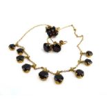 A 9ct yellow gold fringe necklet suspending nine graduated garnets, each beneath a small pearl, l.