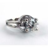 A 14ct white gold ring set brilliant cut diamond in a raised four claw setting,