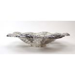 An Edwardian pierced silver dish of circular form decorated in the Rococo manner,