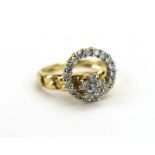 A 14ct yellow gold ring centrally set with six small diamonds in a flowerhead setting within an