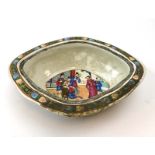 A Cantonese dish of oval form decorated in coloured enamels with an interior scene, d. 23.