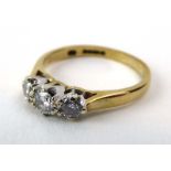 A 9ct yellow gold ring set three graduated diamonds in an inline setting, ring size J, 1.