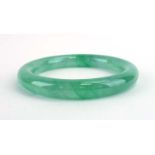 A pale green jade bangle, internal d. 5.