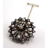 An early 20th century yellow and white metal highlighted pendant brooch of flowerhead form set