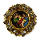 An Italian School hand painted porcelain plaque depicting the Madonna and child in a gilt wood
