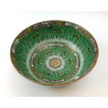A 19th century Cantonese bowl decorated in coloured enamels with butterflies on a green leafy