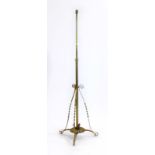 A brass and copper adjustable standard lamp in the manner of W.A.S.
