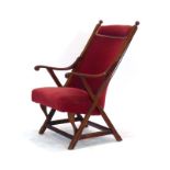 An early 20th century mahogany and upholstered armchair with an X-type frame