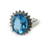 A 9ct white gold cluster ring set oval topaz within a border of small diamonds, ring size R, 4.