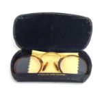 A pair of early 20th century tortoise-shell spectacles with a 9ct gold bridge,