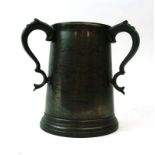 A 19th century pewter three-handled tankard with a glass base, inscribed 'J.E.B.E.