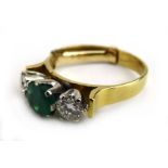 An 18ct yellow gold ring set circular emerald and two small diamonds, diamond approximately 0.