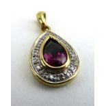 A 9ct yellow gold pendant set teardrop shaped iolite within a border of small diamonds, l. 2.