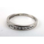 A platinum half eternity ring set graduated diamonds in a tension channel-type setting, total 0.