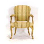 A Louis XV-style giltwood and gold upholstered armchair on cabriole legs