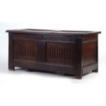 An 18th century and later oak coffer with a carved front on square stiles, w.