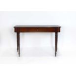 A 19th century mahogany and strung writing table with a tooled leather surface over a single drawer,