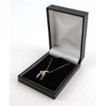A 14ct yellow gold fine chainlink necklace suspending a 9ct yellow gold 'claddagh' pendant,
