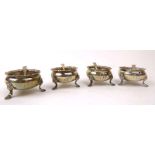 A set of four Edwardian silver salts of squat bun shaped form with gadrooned borders and hoof feet,