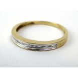 A 9ct yellow gold half eternity ring set baguette cut diamonds in a channel-type setting,