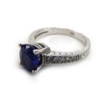 An 18ct white gold ring set oval sapphire in a four claw setting,