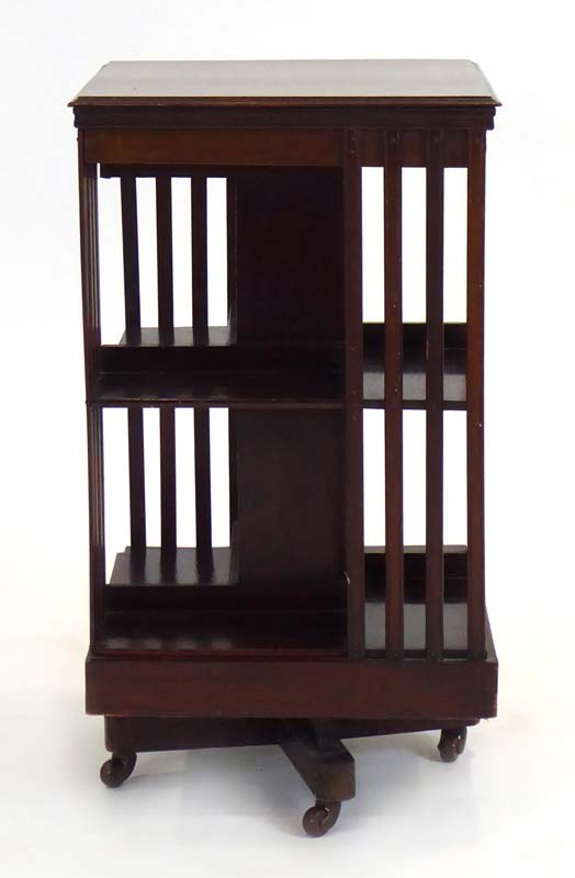 An Edwardian walnut, crossbanded and marquetry revolving bookcase, h.