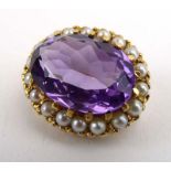 A 19th century-style brooch of oval form set amethyst within a border of small pearls,