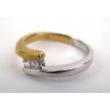 A 9ct two colour crossover ring set two princess cut diamonds, ring size O, 3.