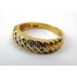 An 18ct yellow gold ring set twenty-one small diamonds in tapered setting, ring size M, 4.