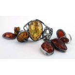 A parcel of silver and metalware amber jewellery comprising a cuff bracelet, four rings,