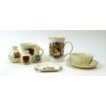 A large collection of Goss, Arcadian and other crested ware including a horseshoe, a WWI tank,
