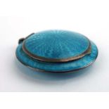 A small silver gilt and pale blue gillouche enamelled compact of circular form, d. 4.