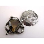 A metalware brooch of openwork form inset heart shaped smoky quartz-type stone, w.