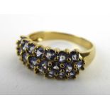 A 9ct yellow gold ring set three rows of tanzanite, ring size P, 2.