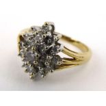 A 9ct yellow gold ring set small diamonds in a snowflake design setting, ring size N, 3.