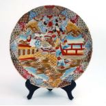A Satsuma charger decorated with a warrior and geisha within a lakeside landscape, d.