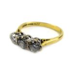 An 18ct yellow gold ring set three graduated diamonds in a raised inline setting,