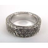 A white metal full eternity ring set three rows of small brilliant cut diamonds,