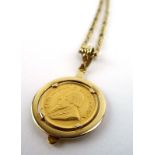 A 9ct yellow gold figaro link necklace suspending a yellow metal pendant set 1/10 Krugerrand dated