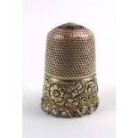 An Edwardian 9ct yellow gold thimble of typical form set small pearls and engraved with a foliate