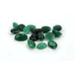 Sixteen loose oval cut emeralds, varying colour and size,