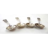 A set of four Chinese metalware spoons with pierced character mark ends and shell bowls,