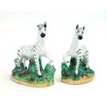 A pair of Staffordshire figures each modelled as a zebra on a naturalist base, max h. 12.