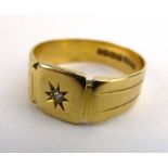 An 18ct yellow gold signet ring set small old cut diamond in a recessed star setting,