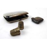 A silver cigarette case, vesta case and two thimbles including an example by Charles Horner,