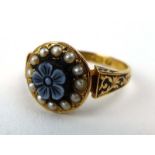 A 15ct yellow gold mourning ring depicting a forget-me-not within a border of seed pearls,