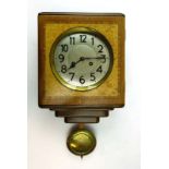 A 1930's wall clock, the silvered dial with Arabic numerals, within a walnut and crossbanded case,